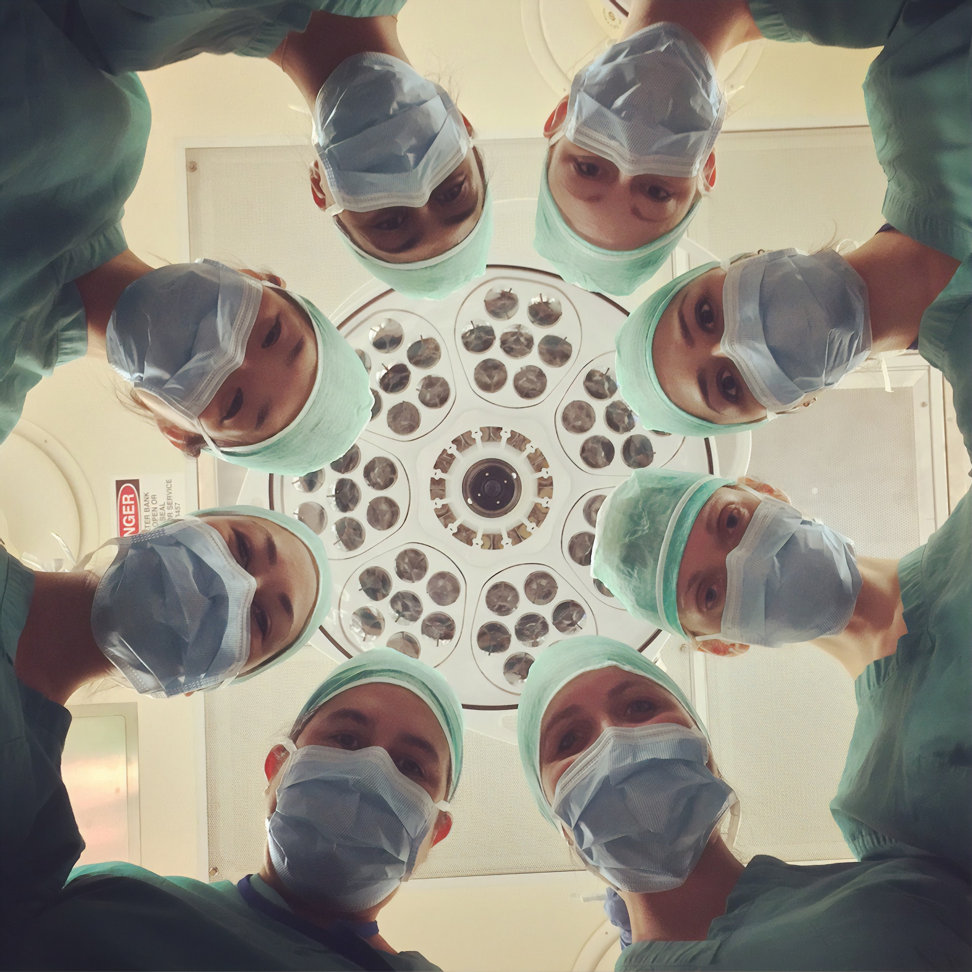 surgeons looking down at a patient